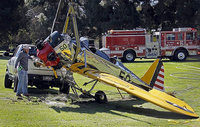 A World War II-era trainer airplane that actor Harrison Ford crash-landed March 5 is removed from Penmar Golf Course in the Venice area of Los Angeles. Federal safety investigators have concluded a problem with a carburetor part led to engine failure and the crash of the vintage airplane.