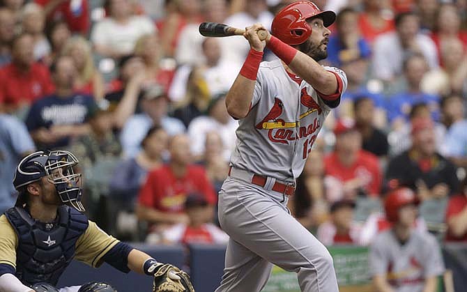 St. Louis Cardinals' Matt Carpenter watches his home run against the Milwaukee Brewers during the first inning of a baseball game Saturday, Aug. 8, 2015, in Milwaukee. 