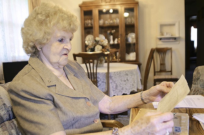 Sue Overland
studies an
ancient
document
she received
from a Belgian
pen pal
years ago.
Now 85,
she's trying
to unravel the
mystery of
the document
her pen pal
said was very
important.