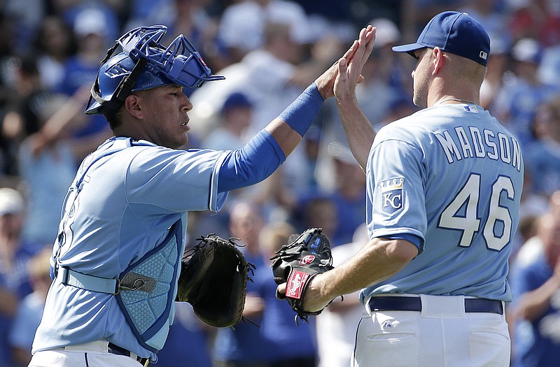 Royals catcher Salvador Perez and reliever Ryan Madson celebrate after Sunday's win against the White Sox in Kansas City.