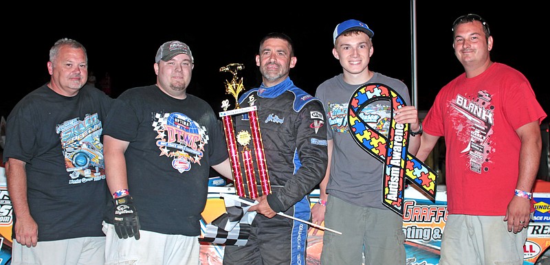 Eldon's Steve Beach celebrates his super stock feature win with team members on Sunday, Aug. 2. Zach Pripusich of Sedalia presented the trophy and displayed the Autisim Awareness ribbon, assisted by Double-X Speedway "Director of Competition' Roy Wood pictured far left.