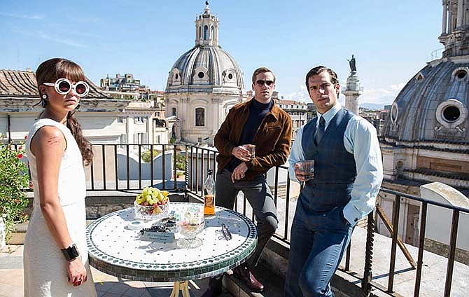 This photo provided by Warner Bros. Pictures shows, Alicia Vikander, from left, as Gaby, Armie Hammer as Illya Kuryakin, Henry Cavill as Napoleon Solo, in Warner Bros. Pictures' action adventure "The Man from U.N.C.L.E.," a Warner Bros. Pictures release. The movie opens Aug. 14, 2015.