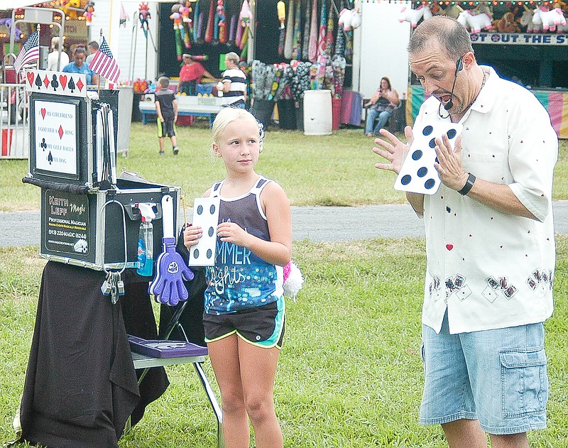 Magician Keith Leff is assisted in his performance by a local girl. In this act, Leff is surprised that more spots keep appearing on the card he is using as he "attempts to explain" how the magic act works.