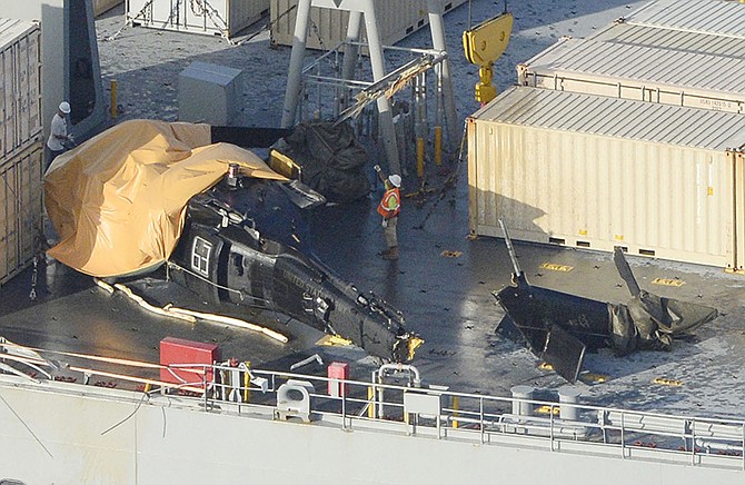 A yellow sheet covers a U.S. Army helicopter U-60 that crashed Wednesday on the Navy cargo vessel USNS Red Cloud in the waters around 20 miles east of Japan's southern island of Okinawa. 