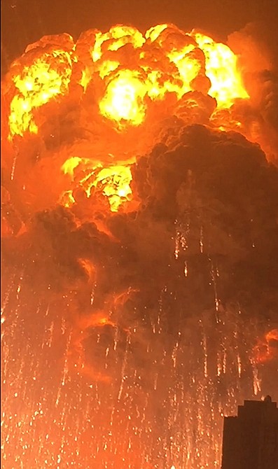 A warehouse explodes Wednesday in Tianjin, China, as filmed from a nearby residential building. Tianjin is the world's 10th largest port. 