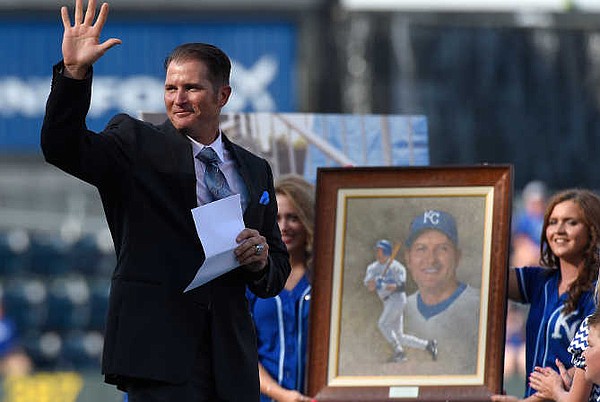 Kansas City Royals first baseman Mike Sweeney holds a Bible as he and his  wife Shara pray during a morning gathering Sunday, March 28, 2004, on the  outfield spectator grass at Surprise