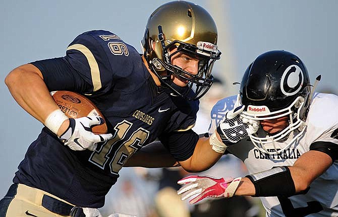 Helias' Adam Bax runs through Centralia's Nick McCoy before scoring Friday in a Jamboree at the Falcon Athletic
Complex in Wardsville, Mo.
