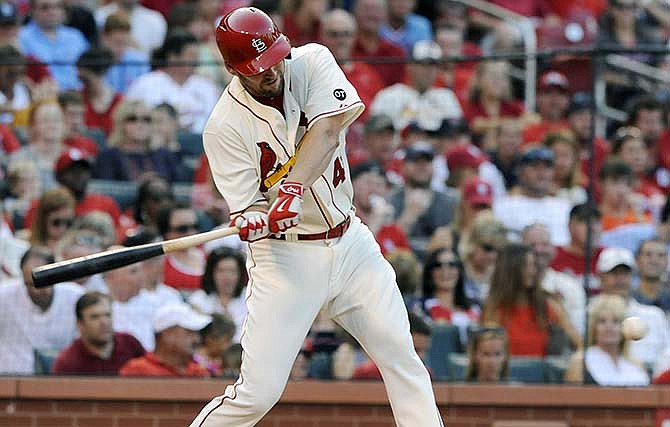 St. Louis Cardinals' starting pitcher John Lackey (41) swings with an RBI single against the Miami Marlins in the second inning of a baseball game, Saturday, Aug. 15, 2015, at Busch Stadium in St. Louis.