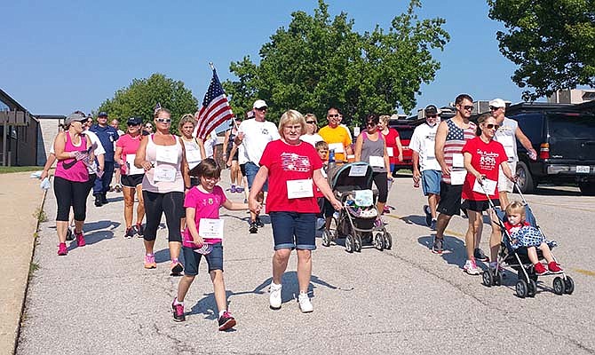 Some of the 100 plus walkers in the Lake of the Ozarks Walk/Run for the Fallen memorial event completing their first mile on Saturday. 