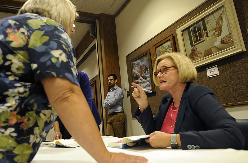 U.S. Sen. Claire McCaskill, right, speaks supporters and well-wishers while signing copies of her new memoir, "Plenty Ladylike," in the Missouri River Regional Library art gallery during Monday evening's Author Talk event.