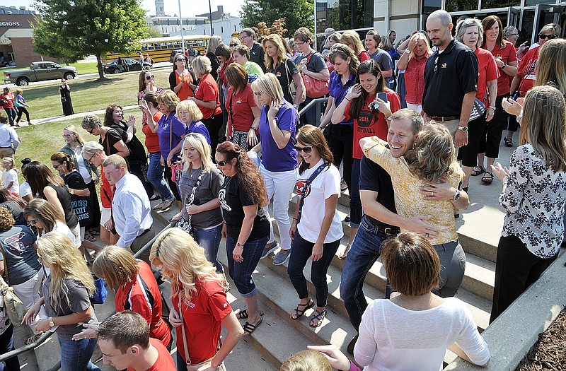 Jefferson City Public Schools held their opening session at Miller Performing Arts Center Monday morning and as teachers and staff exited the building, they were greeted by a number of Central Bank employees who had lined the stairs. In addition to applause and hollers of cheer, the JCHS Drum Line played as the employees exited the building.