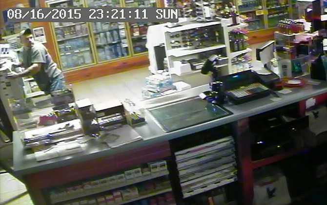 Released by the Maries County Sheriff's Department, this screen grab from a security camera video shows a burglary suspect inside Crossroads Convenience Store near Brinktown, Mo., on Sunday night, Aug. 16, 2015.