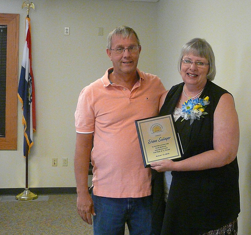 Mayor Norris Gerhart, on behalf of the Califonria Area Chamber of Commerce, presents Diane Eulinger with a retirment plaque and token of the appreciation for timed served as the executive secretary.