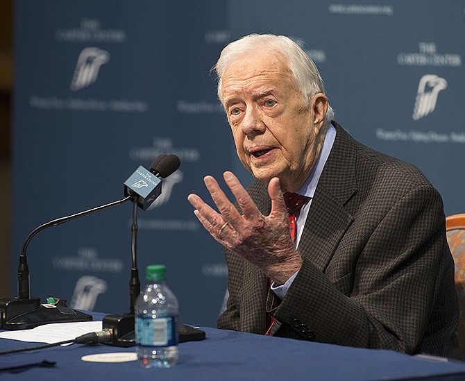 Former President Jimmy Carter talks Thursday about his cancer diagnosis during a news conference at the Carter Center in Atlanta. Carter announced his cancer is on four small spots on his brain and he will immediately begin radiation treatment, saying he is "at ease with whatever comes." 