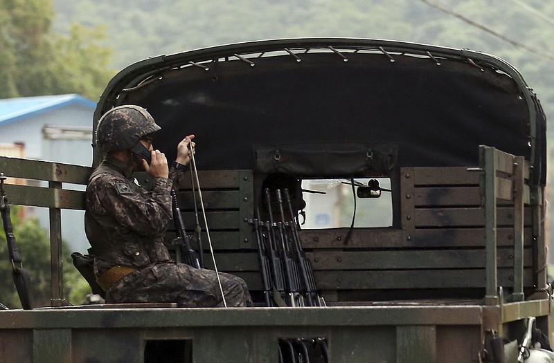 A South Korean soldier uses a radio on a military vehicle at the South Korean border town of Yeoncheon.