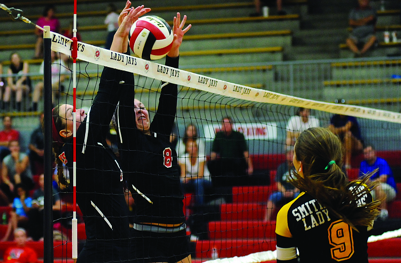 Madisyn Stone (8) of the Jefferson City Lady Jays goes up to block a shot during action against Sedalia Smith-Cotton last season at Fleming Fieldhouse. Stone returns to the Lady Jays' lineup this season.