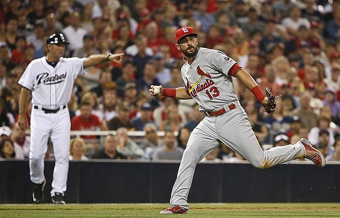 St. Louis Cardinals third baseman Matt Carpenter has no where to throw the ball after fielding a slow roller hit by San Diego Padres' Jedd Gyorko in the fourth inning of a baseball game Friday, Aug. 21, 2015, in San Diego. Gyorko got a hit on the play.