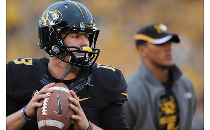In this October 2012 file photo, Missouri quarterback Corbin Berkstresser warms up while injured quarterback James Franklin stands by before the start of the game against Alabama at Faurot Field in Columbia.