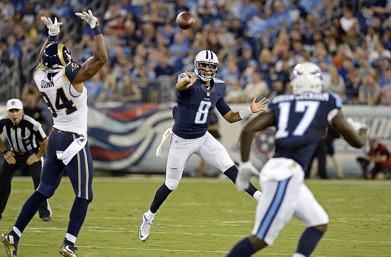 Titans quarterback Marcus Mariota passes to wide receiver Dorial Green-Beckham (17) as Robert Quinn of the Rams defends during the first half of Sunday's preseason game in Nashville, Tenn.