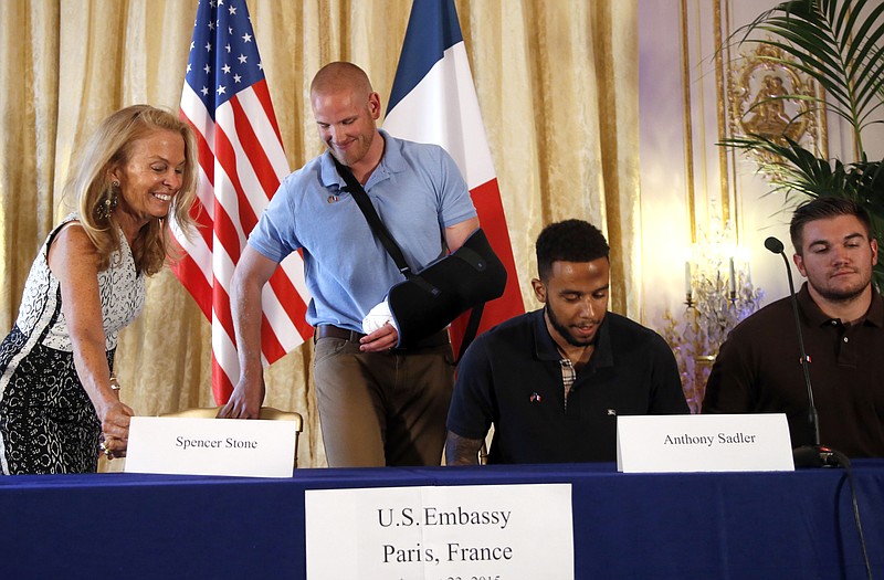 Anthony Sadler, a senior at Sacramento University in California, second right, U.S. National Guardsman from Roseburg, Oregon, Alek Skarlatos, right, U.S. Airman Spencer Stone, second from left, and U.S. Ambassador to France Jane D. Hartley take their seats before a press conference held at the US Ambassador's residence in Paris, France, Sunda. Sadler, Skarlatos and Stone helped foil a potentially deadly attack when they subdued a man armed with an assault rifle and other weapons on board a high-speed train bound for Paris two days ago. The man was known to intelligence services in three countries and had ties to radical Islam, authorities said Sunday. (AP Photo/Francois Mori)