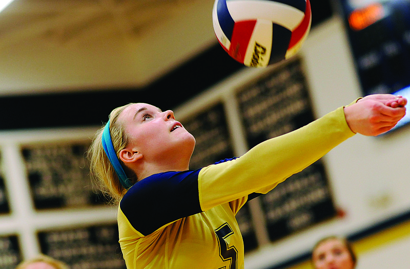 Helias setter Ashley Dudenhoeffer scrambles to bump a ball back in play for the Lady Crusaders during a match last season at Rackers Fieldhouse.