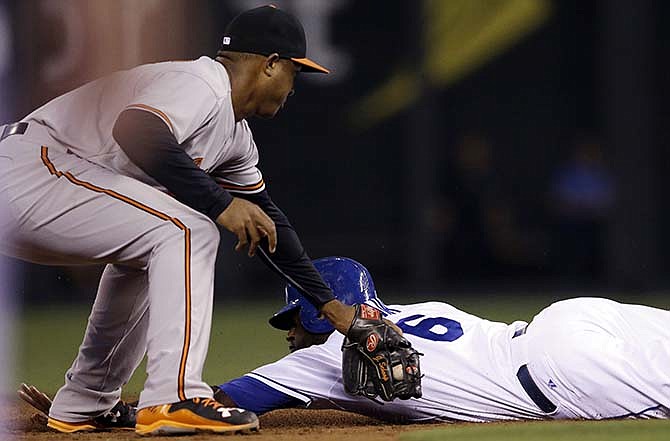 Kansas City Royals' Lorenzo Cain (6) beats the tag by Baltimore Orioles second baseman Jonathan Schoop during the third inning of a baseball game at Kauffman Stadium in Kansas City, Mo., Tuesday, Aug. 25, 2015. Cain was safe on a fielders choice. 