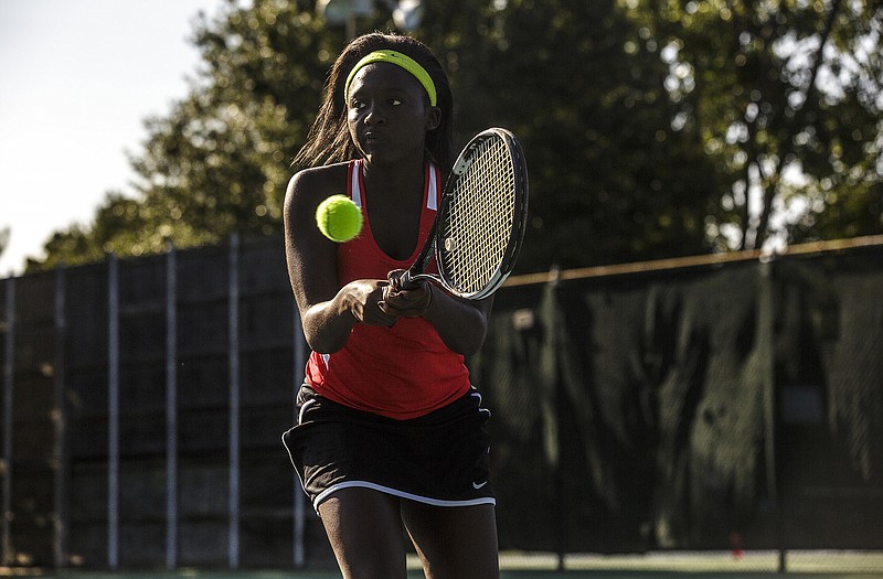 Esther Ruboneka of the Lady Jays eyes the ball before sending a backhand return during action Tuesday afternoon against Rolla at Washington Park.