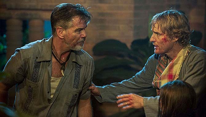 In this image released by The Weinstein Company, Pierce Brosnan, left, and Owen Wilson appear in a scene from, "No Escape."