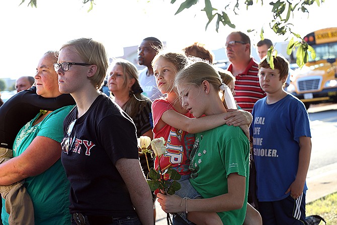 Amanda Rothkopf, 11, and her sister Lyndsye, 9, both of Salem, came to pray for WDBJ7's Digital Broadcast Center's shooting victims in Roanoke, Virginia, Wednesday. The shooting of a television reporter and a cameraman unfolded on live TV before an audience of tens of thousands on the smaller market central Virginia television station. 