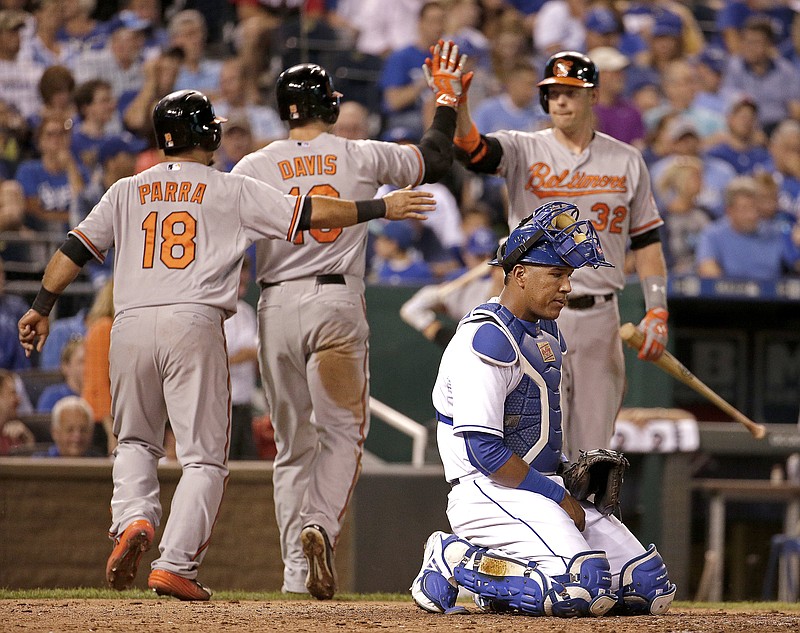 The Orioles' Chris Davis (center back) celebrates with teammate Gerardo Parra (18) and Matt Wieters (32) after hitting a two-run home run during the fifth inning of Wednesday's game against the Royals in Kansas City. 