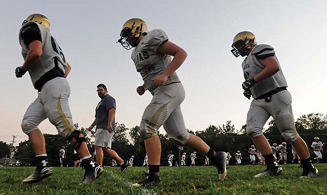 The
Helias
Crusaders
go
through
a conditioning
drill
during
preseason
practice
earlier
this
month.