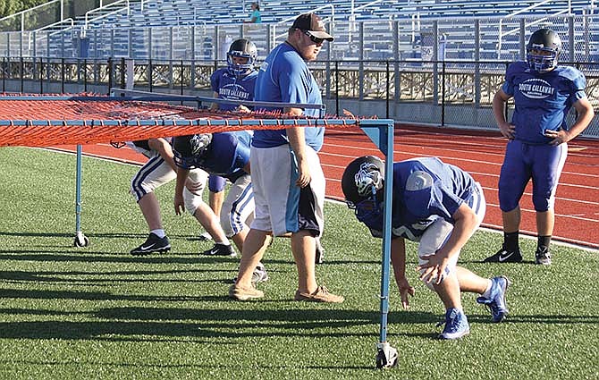 South Callaway linemen work on keeping their angles low while assistant coach Nick Trammell observes at Tuesday's practice in Mokane, Mo.