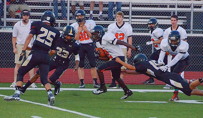 
Sam Bowman of Versailles extends to make a tackle on E.J. Walton of Knob Noster during Versailles' season opener last Friday.