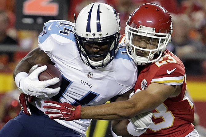 Tennessee Titans wide receiver Hakeem Nicks (14) is tackled by Kansas City Chiefs defensive back Phillip Gaines (23) during the first half of a preseason NFL football game at Arrowhead Stadium in Kansas City, Mo., Friday, Aug. 28, 2015.