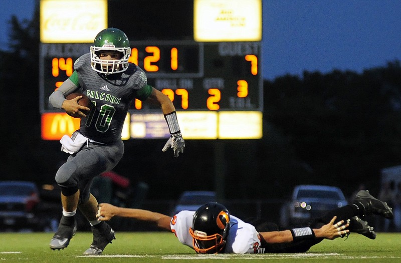 Blair Oaks quarterback Jordan Hair (10) accelerates to the sideline as Owensville strong safety Robert Wierich (26) lunges in vain for Hair's legs during Friday night's game at the Falcon Athletic Complex in Wardsville.