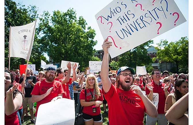 First year graduate student Drew Amidei, front right, screams with others during a "day of action" to celebrate graduate students and draw attention to demands Wednesday, Aug. 26, 2015, near the columns on the University of Missouri campus, in Columbia, Mo. (Daniel Brenner/The Columbia Daily Tribune via AP) 