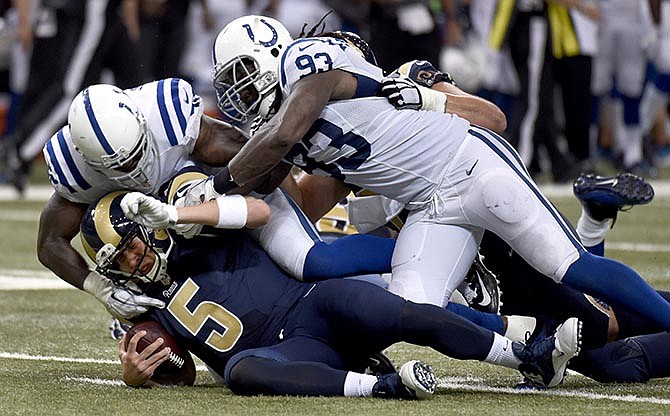 St. Louis Rams quarterback Nick Foles (5) is sacked for a 10-yard loss by Indianapolis Colts' D'Qwell Jackson, top left, and Erik Walden during the second quarter of an NFL preseason football game Saturday, Aug. 29, 2015, in St. Louis.