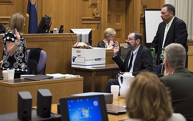 Frazier Glenn Miller Jr. is sworn in before taking the witness stand during his capital murder trial in the Johnson County Courthouse on Friday, Aug. 28, 2015, in Olathe, Kan. Miller is charged with the April 13, 2014 shooting deaths of three people outside of Overland Park Jewish facilities in suburban Kansas City. (Shane Keyser /The Kansas City Star via AP, Pool)