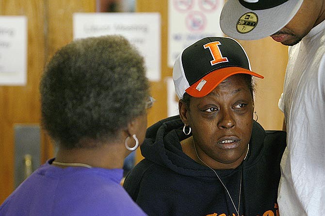In this Oct. 8, 2009 photo, Annette Nash, center, mother of Anthony Rice is comforted by her mother Ruth Nash, left and her son Deaundra Dyson. It's been almost six years since Rice died in a strip club parking lot in East St. Louis, Ill., after being run over by a bouncer's pickup truck, Scheduled hearings in the case have been postponed 16 times since Reginald Allen was charged with reckless homicide in 2011, nearly two years after Rice's death. Allen remains free on bail. 