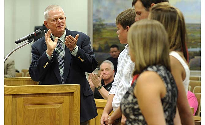 Jefferson City Parks, Recreation and Forestry Director Bill Lockwood, left,
applauds Ellis-Porter pool lifeguards Sam Dudenhoeffer, Spencer Wolf, Cayce
Heiberger, and assistant pool manager Audrey Kruse during a special recognition
ceremony at the city council meeting. After more than 33 years, Lockwood
is retiring March 2016.