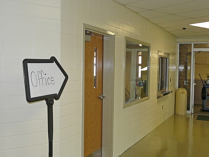 With a sign directing students and visitors to the new Blair Oaks High School office, this view shows the new entrance door and the two windows that allow the staff to monitor the hallways and the front door.