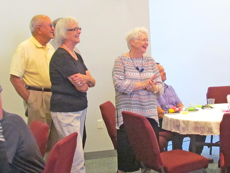 Retiring Fulton City Clerk Carolyn Laswell (right) shares a laugh with others while viewing a slide show depicting her life, including her career at city hall as well as selected pictures from her youth.