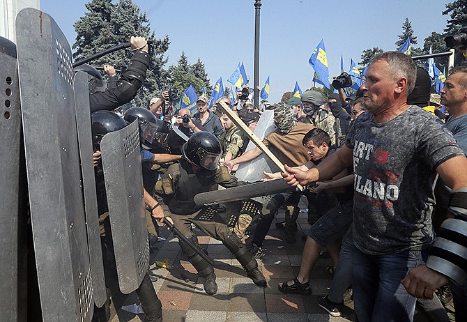Ukrainian protesters clash with police Monday after a vote to give greater powers to the east, outside the Parliament, Kiev, Ukraine. 