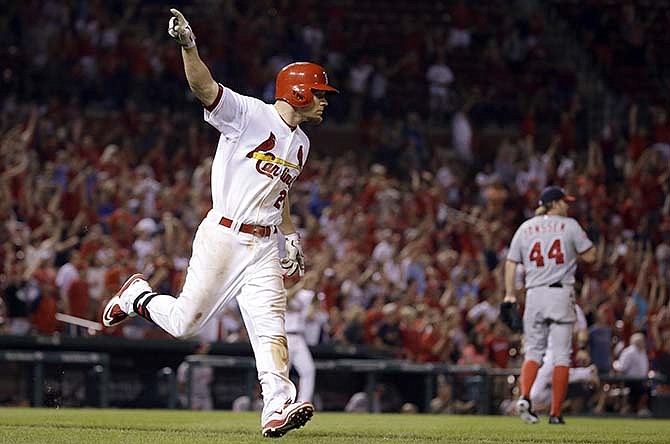 St. Louis Cardinals' Brandon Moss celebrates after hitting a walk-off three-run home run off Washington Nationals relief pitcher Casey Janssen (44) during the ninth inning of a baseball game Tuesday, Sept. 1, 2015, in St. Louis. The Cardinals won 8-5.