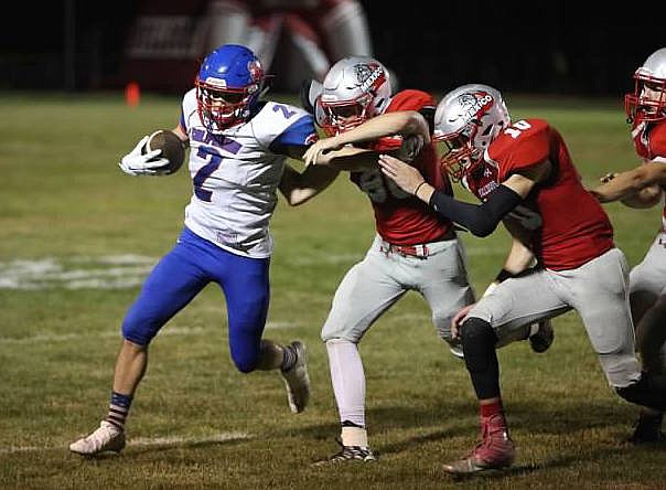 Dylan Ratcliff fights off tacklers during the second half Friday night.