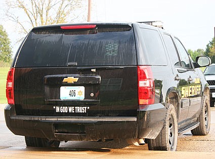 A parked Callaway County Sheriff patrol vehicle sports the nation's motto on a bumper sticker Tuesday. It was added last week after the Missouri Sheriffs Association came to a unanimous vote for departments to add the bumper stickers to their patrol vehicles.