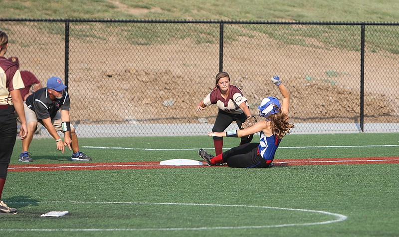 Jenna Reynolds slides under a tag at third base in the second inning on Tuesday. Reynolds eventually scored one batter later.