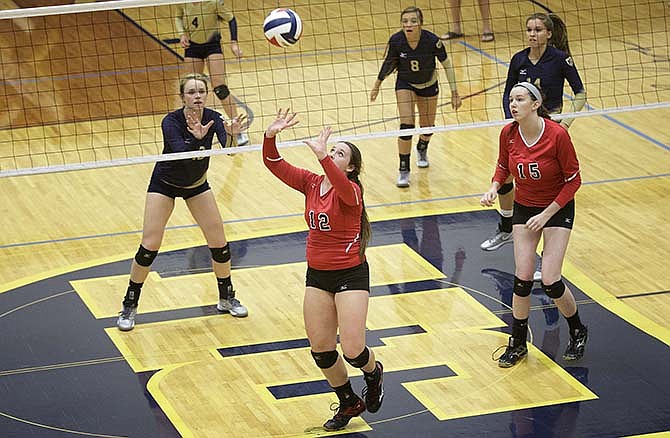 Jefferson City's Janice Steacy prepares to set the ball during Tuesday's match with
Helias at Rackers Fieldhouse. Looking on (from left) are Suzie Kuensting, Maddie
Dunkmann and Ellie Rockers of the Lady Crusaders and Mary Wehmeyer of the Lady
Jays.