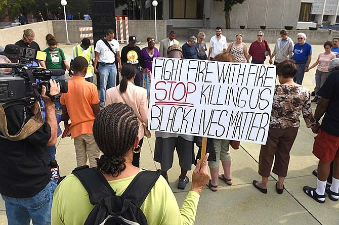 In this Friday, Aug. 28, 2015 photo, dozens of people gather during a rally outside the Frank Murphy Hall of Justice in Detroit regarding the shooting death of Terrance Kellom by an U.S. Immigration and Customs Enforcement (ICE) officer in April 2015. As the Black Lives Matter movement gains more public attention, there are questions being raised about who's in charge of the movement and what its long-term goals are. (Max Ortiz/The Detroit News via AP)