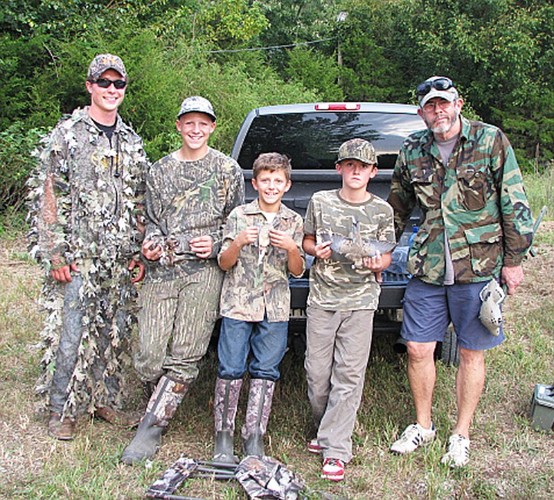 Guide Brady Lichtenberg (left) stands with attendants of the Missouri Department of Conservation's youth dove hunt at the Reform Conservation Area, Tuesday. During the hunt from 3 p.m. to sunset, hunters were allowed to harvest up to 15 doves, which is the legal limit during dove season.